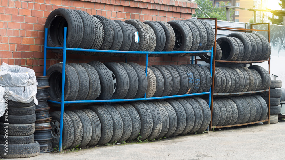 Car tires are on racks nea service station. Car tires are on racks nea service station.