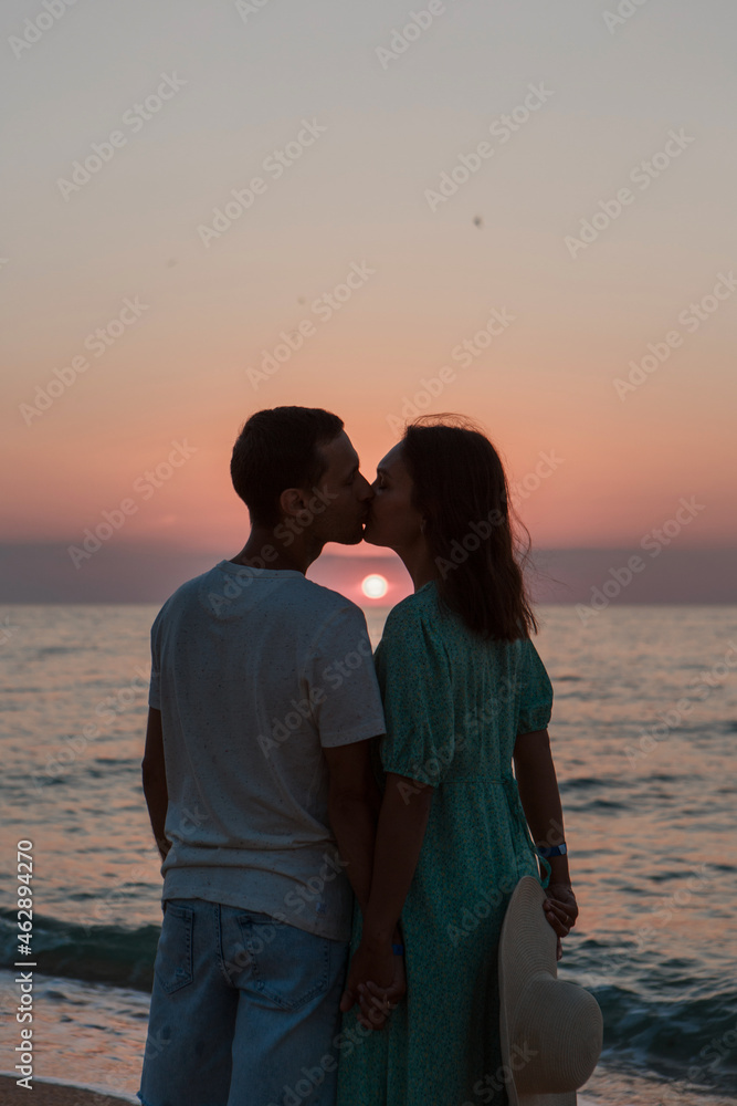 a guy and a girl on the sea. Couple love in water. people on the beach