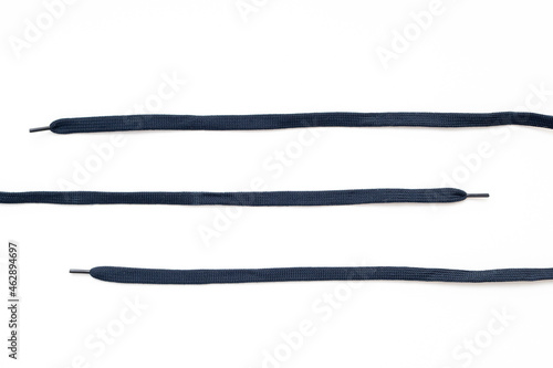 Parallel shoelaces isolated on white, dark-blue laces, top view