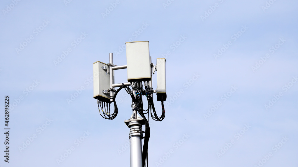 Telecommunication pole of 4G and 5G cellular. Macro Base Station. 5G radio network telecommunication equipment with radio modules and smart antennas mounted on a metal against sky background.