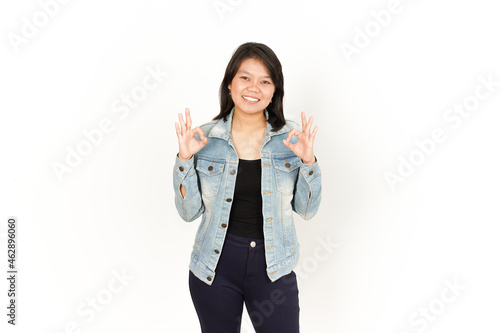 Showing Ok Sign of Beautiful Asian Woman Wearing Jeans Jacket and black shirt Isolated On White Background
