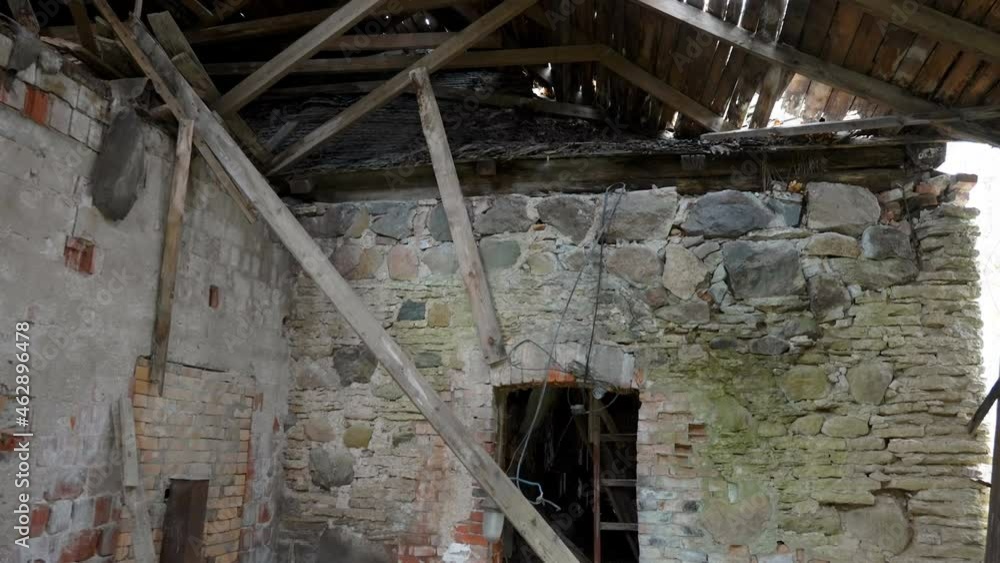A part of the abandoned ruined house with the fallen wooden ceiling on the ground in Estonia A part of the abandoned ruined house with the fallen wooden ceiling on the ground in Estonia
