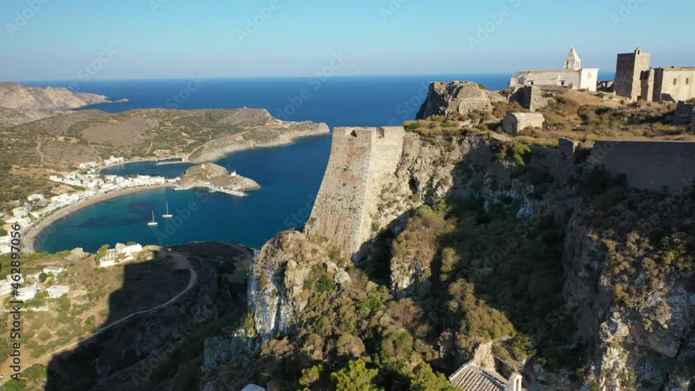 Aerial drone video of iconic medieval castle of main village of Kithira island overlooking beautiful double bay and beach of Kapsali, Kythira island, Ionian, Greece Aerial drone video of iconic medieval castle of main village of Kithira island overlooking beautiful double bay and beach of Kapsali, Kythira island, Ionian, Greece