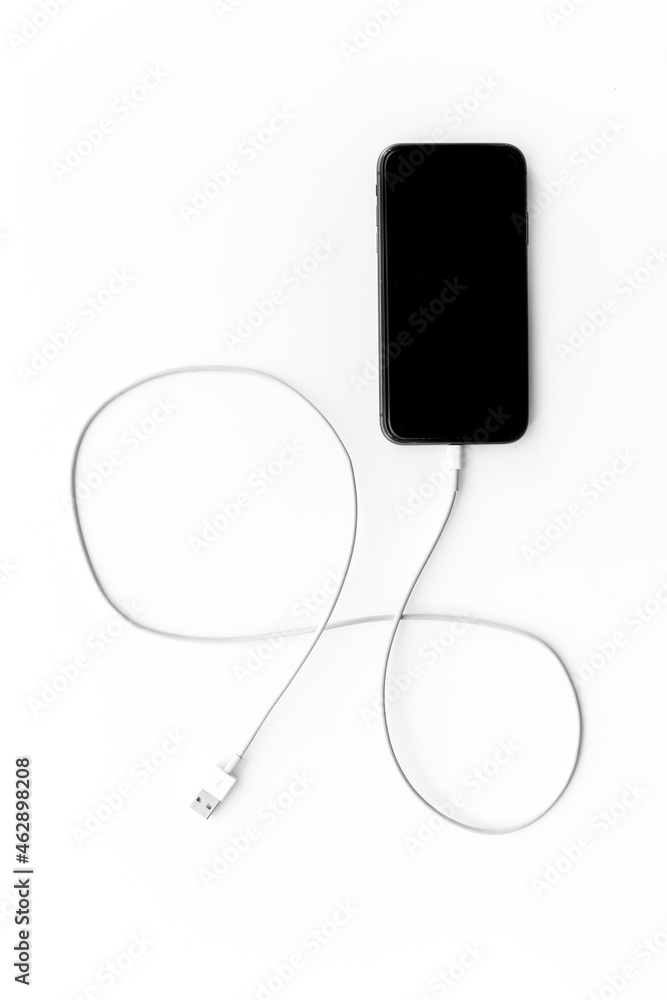 Cord charger with cable for mobile phone or laptop, top view Cord charger with cable for mobile phone or laptop, top view