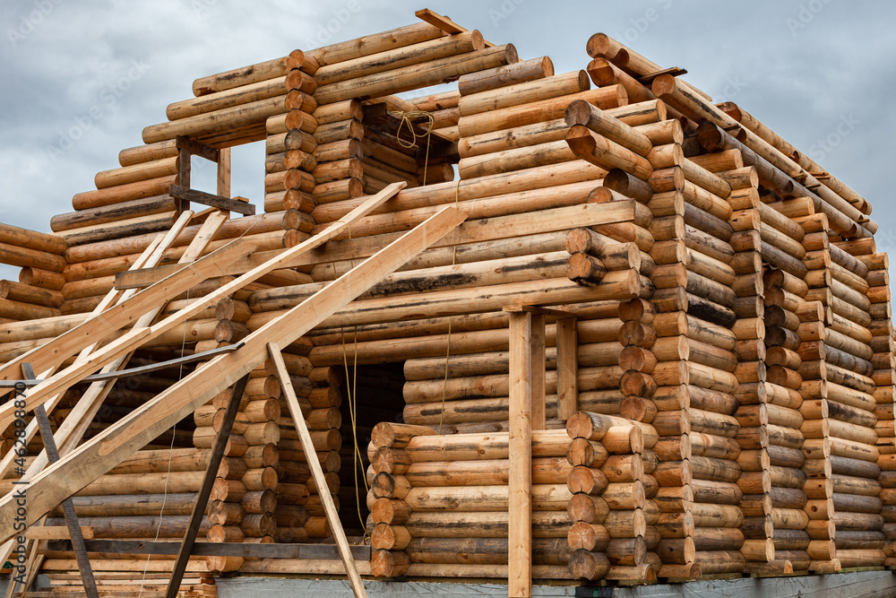 a wooden house under construction a log house consisting of two floors a wooden house under construction a log house consisting of two floors