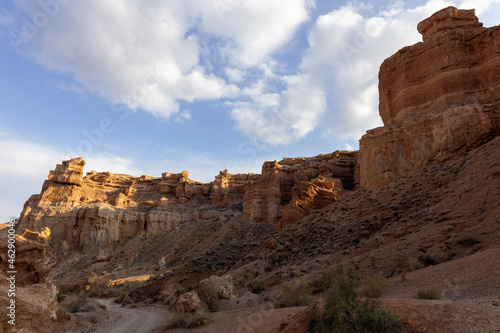 The multicolored rock layers of Charyn canyon are the product of different stages of sediment deposits, which includes volcanic lava rocks at the bottom, and red debris on top. Charyn National Park.