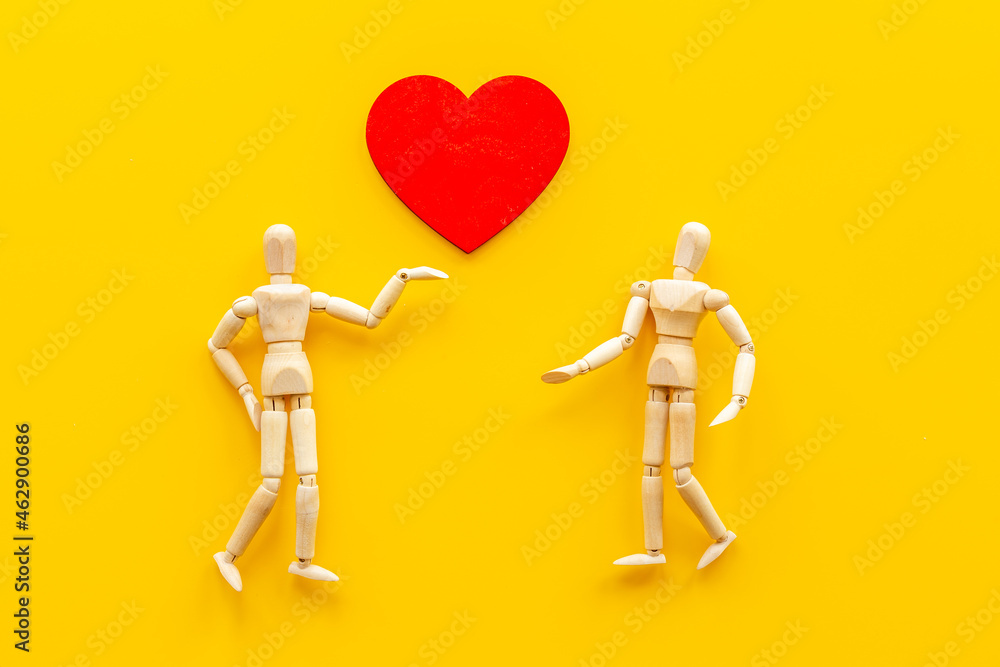 Couple of wooden mannequin figures with heart. Love and dating concept Couple of wooden mannequin figures with heart. Love and dating concept