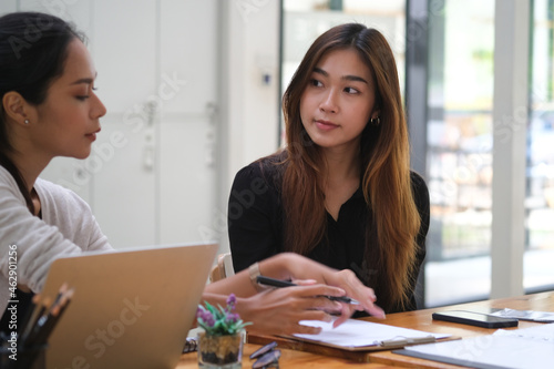 Wallpaper Mural Photo of the designer team meeting at the wooden table surrounded by a computer laptop and various stuff. Torontodigital.ca
