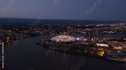 Evening aerial view of Millennium Dome. O2 arena at night. Illuminated city streets and buildings. London, UK photo