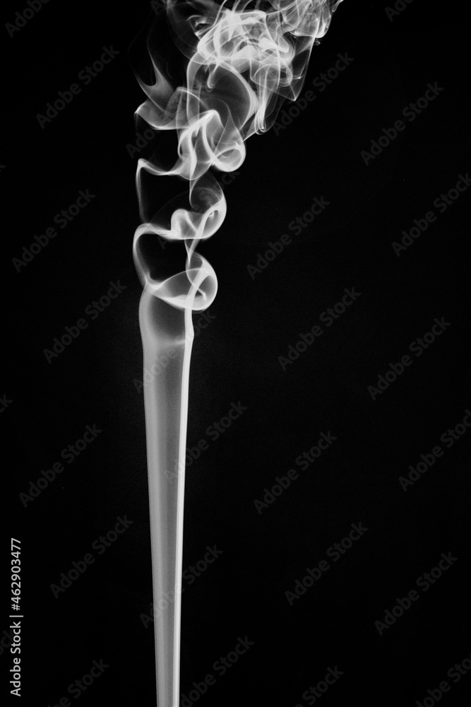 Swirly movement of white smoke on black background, looks like an abstract art Swirly movement of white smoke on black background, looks like an abstract art