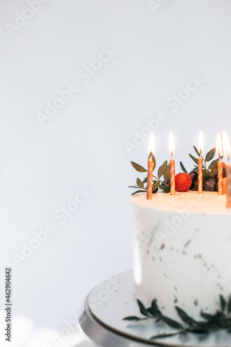 Papier peint White creamy minimalistic style cake with candles decorated with fresh berries,