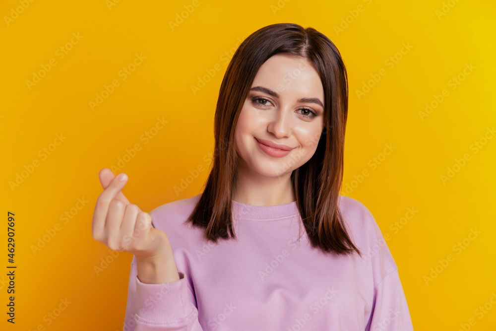 Photo of young beautiful charming pretty positive good mood smiling girl asking money isolated on yellow color background Photo of young beautiful charming pretty positive good mood smiling girl asking money isolated on yellow color background