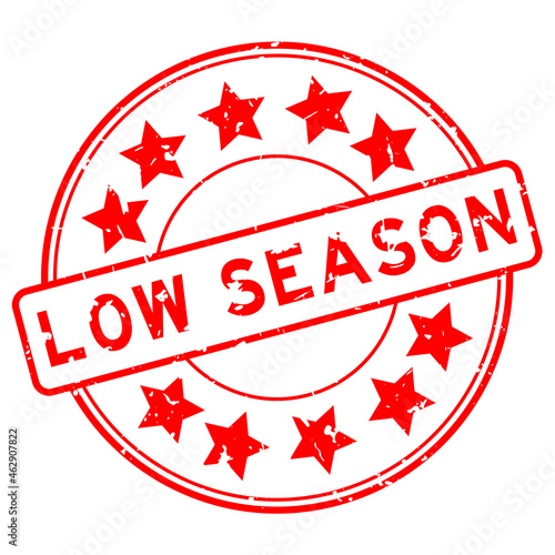Grunge red low season word with star icon round rubber seal stamp on white background