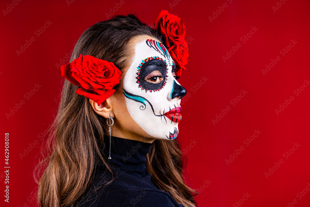 1st and 2nd november celebration of day of the dead in mexico concept woman with grimm skull face and black cloth in studio