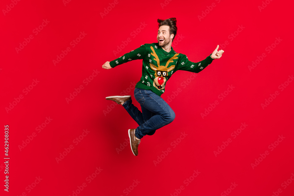 Full size profile side photo of smiling good mood male running fast speed playful escape isolated on red color background