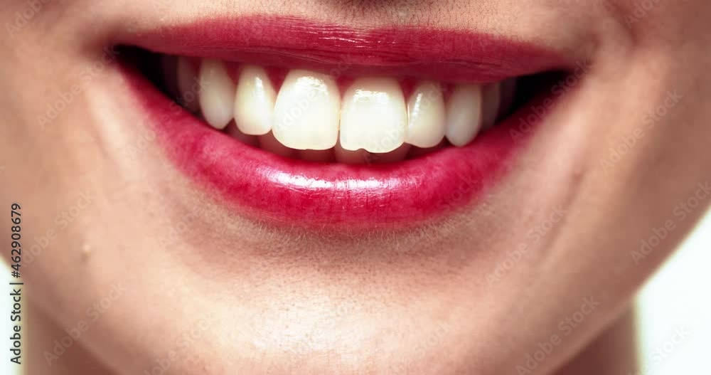 Close up of healthy smile of beautiful caucasian woman with pink lipstick on lips. Dental care advertising concept. Close up of healthy smile of beautiful caucasian woman with pink lipstick on lips. Dental care advertising concept.
