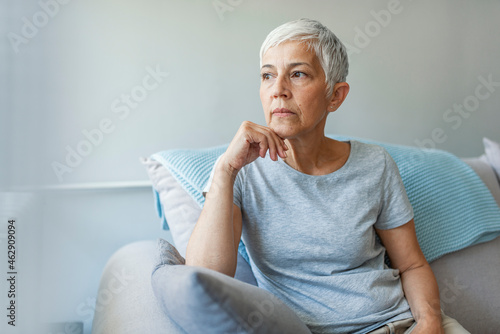 Canvas Print Pensive thoughtful middle aged lady looking away sit alone at home feel anxious