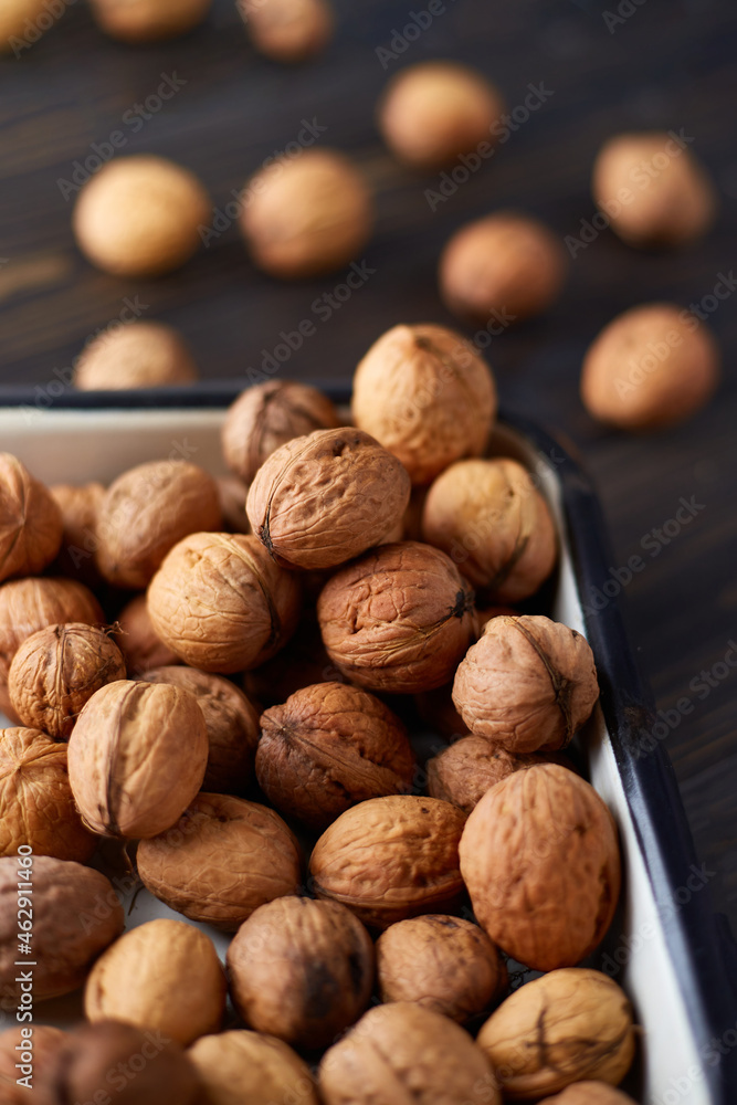 Natural whole walnuts on dark wooden table Natural whole walnuts on dark wooden table