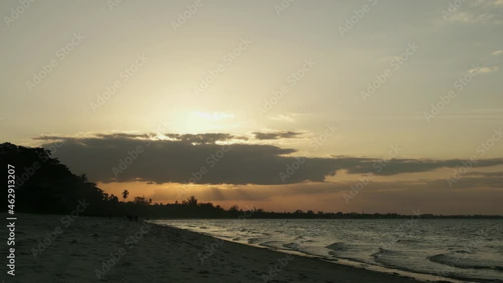 The Sun is settle on the horizon and sea waves brushes the shore of Bagamoyo beach The Sun is settle on the horizon and sea waves brushes the shore of Bagamoyo beach