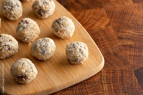 Group of Coconut Chocolate Energy Balls on a Wooden Butcher Block