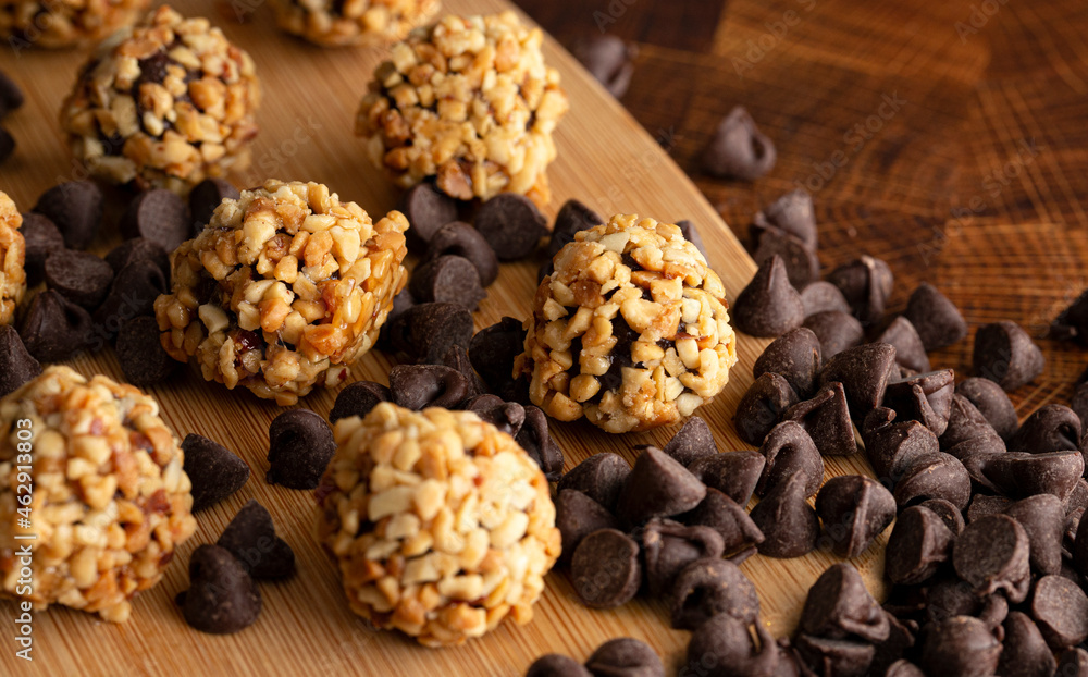 Group of Chocolate Peanut Butter Energy Balls on a Wooden Butcher Block Group of Chocolate Peanut Butter Energy Balls on a Wooden Butcher Block