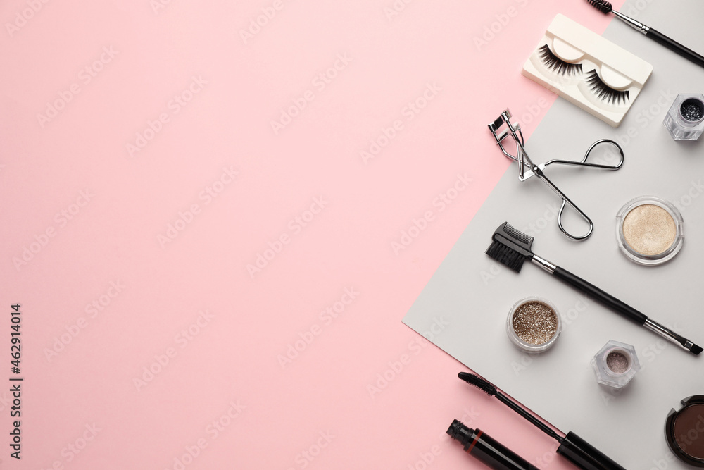 Flat lay composition with eyelash curler, makeup products and accessories on pink background. Space for text Flat lay composition with eyelash curler, makeup products and accessories on pink background. Space for text