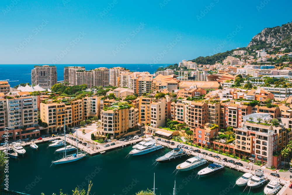 Obraz premium Yachts moored near city Pier, Jetty In Sunny Summer Day. Monaco, Monte Carlo