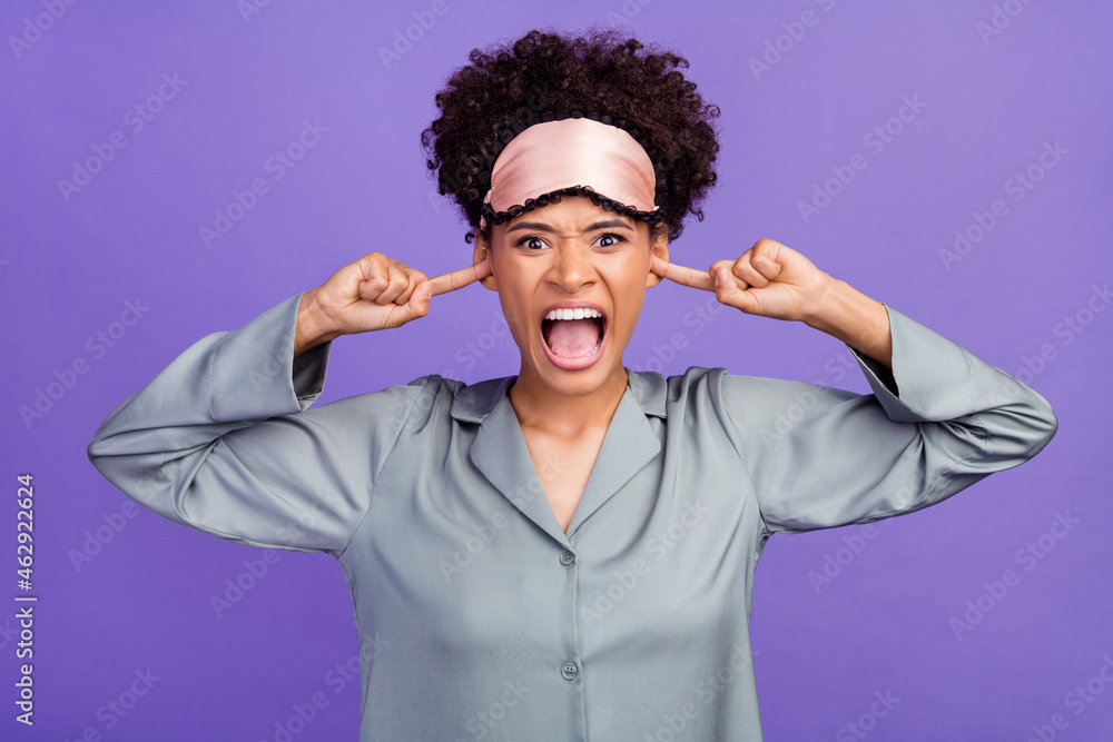 Photo of angry upset woman grey sleepwear finger cover ears screaming noisy neighbors isolated violet color background Photo of angry upset woman grey sleepwear finger cover ears screaming noisy neighbors isolated violet color background