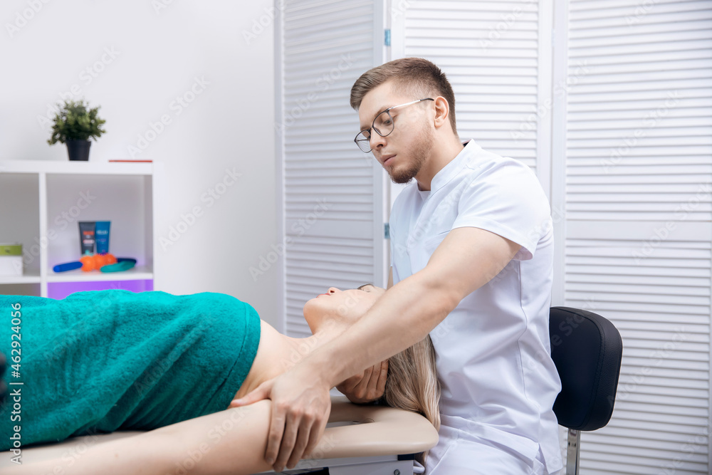 Therapist osteopathy working sports massage with shoulders of woman athlete Therapist osteopathy working sports massage with shoulders of woman athlete