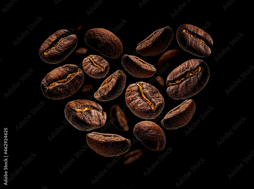 Coffee beans in the shape of a heart on a black background Coffee beans in the shape of a heart on a black background