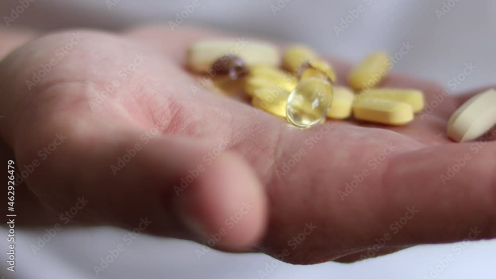 Vitamins And Supplements. male Hand Holding Colorful Pills. Vitamins And Supplements. male Hand Holding Colorful Pills.