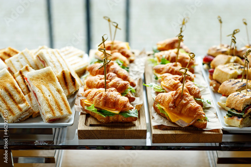 Tablou pe pânză Stacks of croissant sandwich at event.