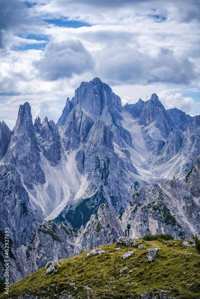 Woman hiker with backpack against Cadini di Misurina mountain group range of Italian Alps, Dolomites, Italy, Europe Woman hiker with backpack against Cadini di Misurina mountain group range of Italian Alps, Dolomites, Italy, Europe