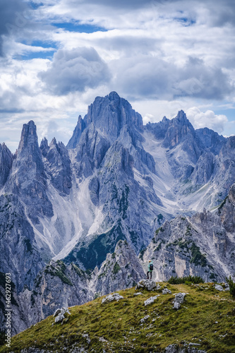 Woman hiker with backpack against Cadini di Misurina mountain group range of Italian Alps, Dolomites, Italy, Europe