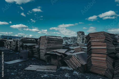 Photo of a large amount of cardboard in a garbage dump photo