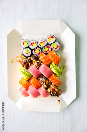 Tasty Colorful assorted Set of different type Sushi. Dinner in Japanese style. Healthy food concept. Filadelfia and Maki sushi rolls with Avocado, Tuna, Salmon, fish and Prawns. Vegetarian food..