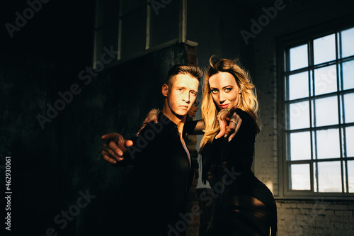 Portrait of Couple two professional ballroom dancers in loft studio. Sport life concept. Passion and emotional dance.