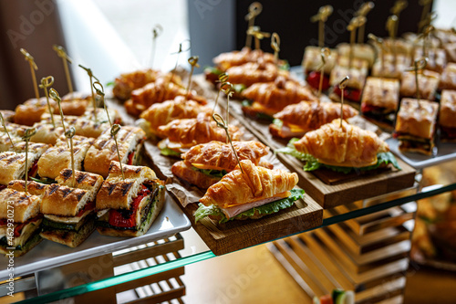 Fotografía Stacks of croissant sandwich at event.