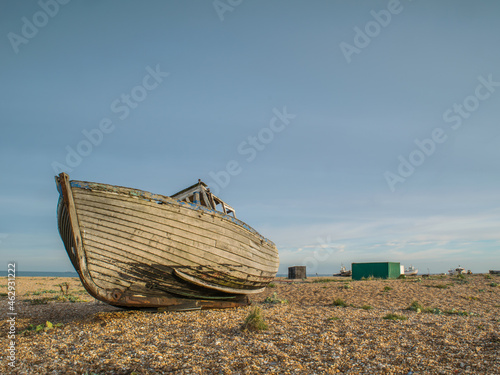 Abandoned wooden fishing boat wreck at the beach of Dungeness, Kent, England photo