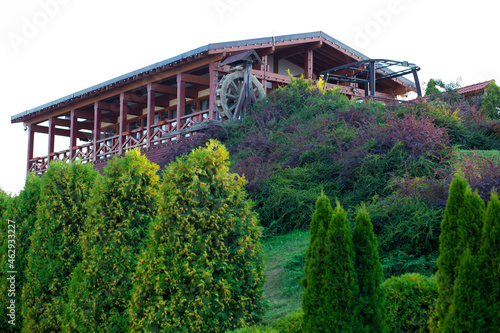 Wooden restaurant with a water mill on the mountain