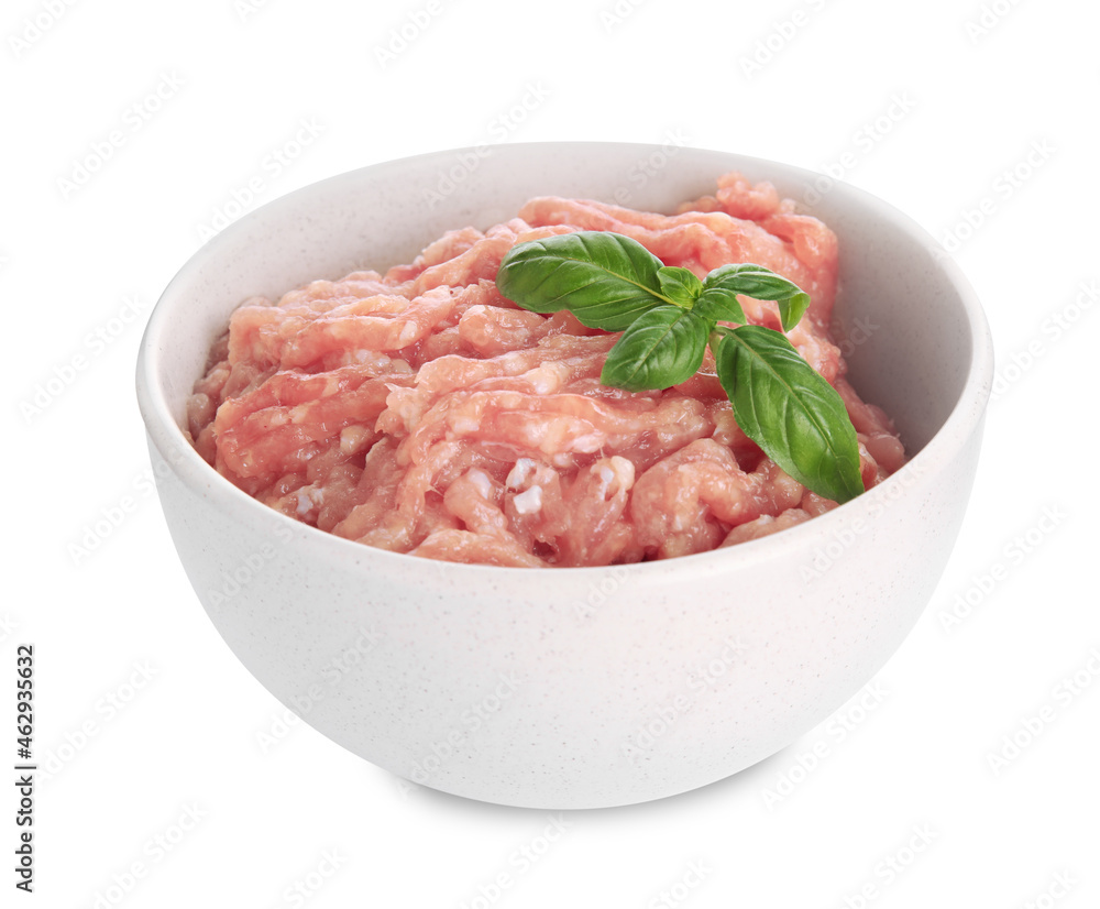 Raw chicken minced meat with basil in bowl on white background