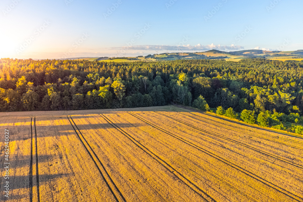 Rural agricultural landscape in summer evening. Aerial view from drone.
