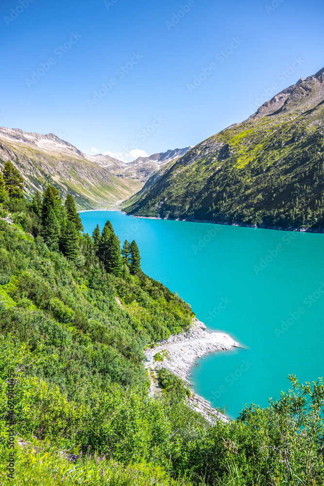 Vivid blue mountain lake in summer Alps. Speicher Zillergrundl dam, Zillertal Alps, Austria