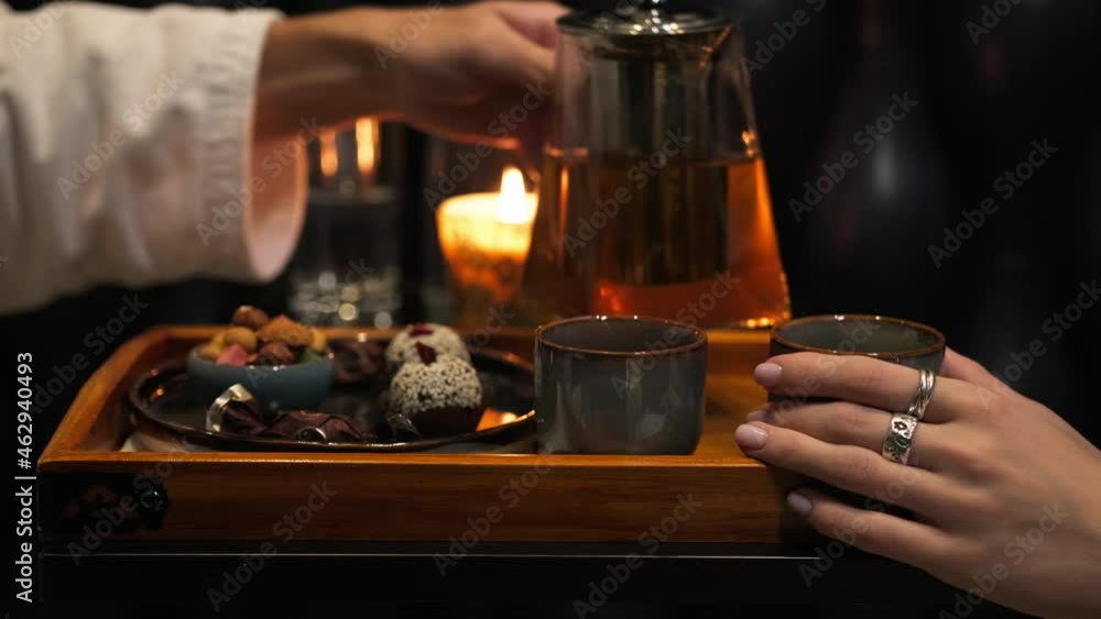 Tea ceremony. A young couple brews and pours tea. Tea ceremony. A young couple brews and pours tea.