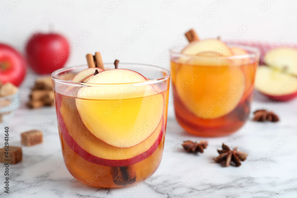 Aromatic hot mulled cider on white marble table Aromatic hot mulled cider on white marble table