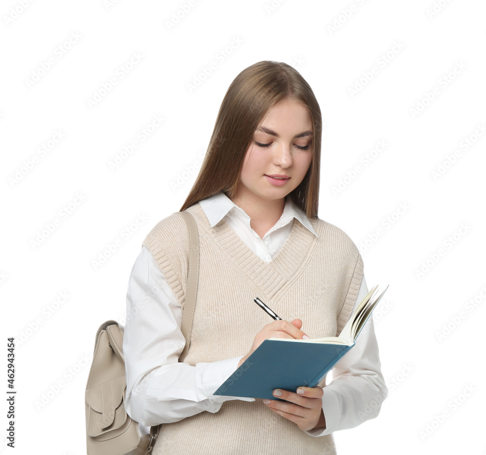 Teenage student with backpack writing in notebook on white background Teenage student with backpack writing in notebook on white background