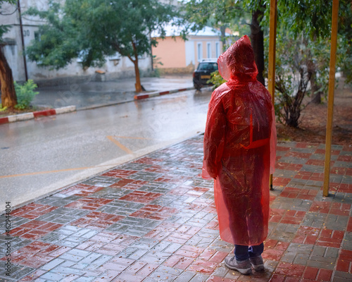 The woman is hiding from the rain.