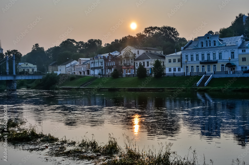 Torzhok embankment at sunrise. Tvertsa River