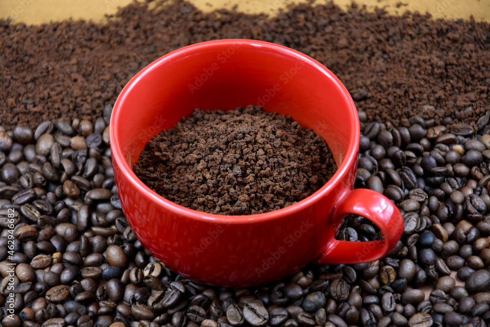 Red mug with roasted coffee beans stock images. Pile of roasted coffee beans and ground instant coffee stock images Red mug with roasted coffee beans stock images. Pile of roasted coffee beans and ground instant coffee stock images
