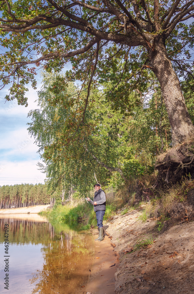 Fisherman on the bank of a beautiful river. Fisherman on the bank of a beautiful river.